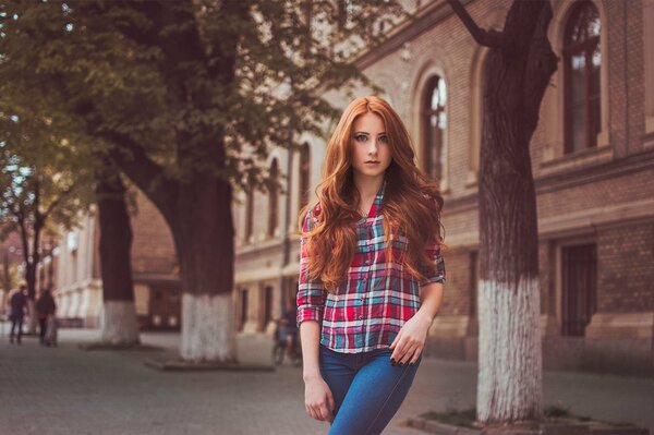 A girl in a plaid shirt and jeans