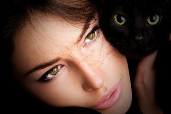 Fille aux yeux verts avec chat noir aux yeux verts