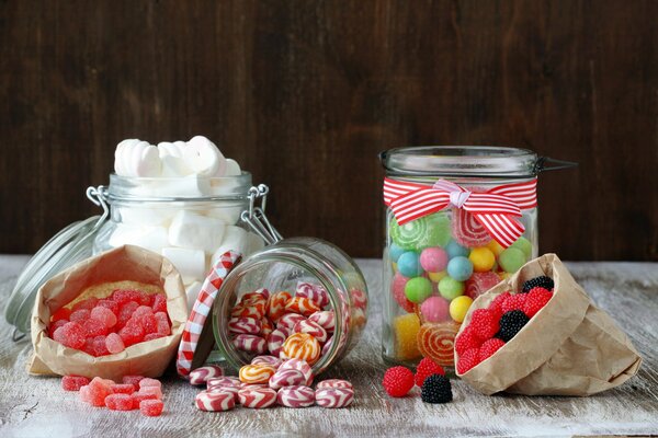 Lollipops candies marmalade in glass jars