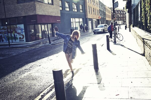 A girl in a denim jacket rejoices in the sun