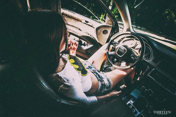 A girl driving a retro audi car