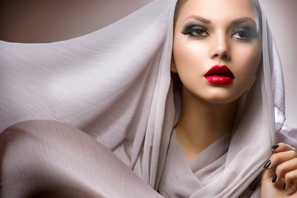 A girl in a headscarf. Red lips