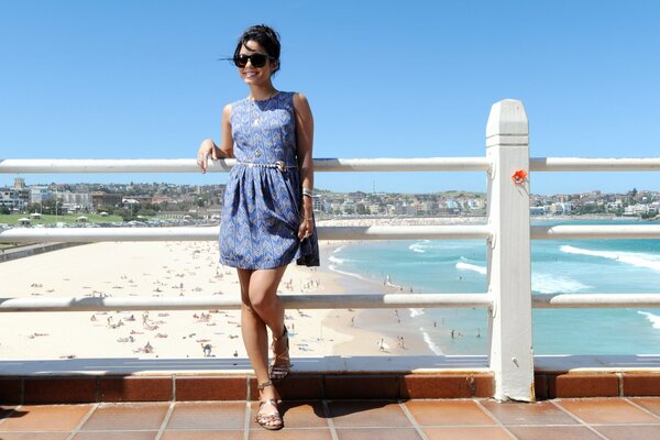 Girl with glasses on the background of the shore