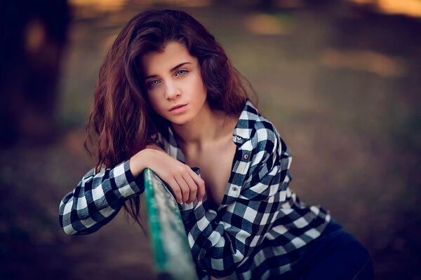 Brunette girl in a plaid shirt