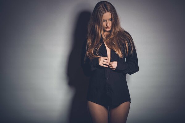 A girl in a black shirt on a gray background