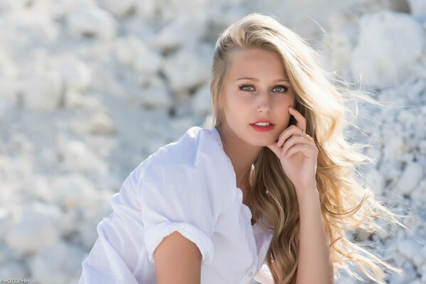 Belle fille aux cheveux blonds en blouse blanche