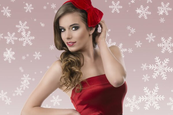 A girl in a red dress with a bow on her hair