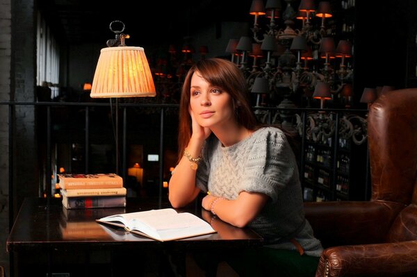 Irina Muromtseva reads a book in a dark room