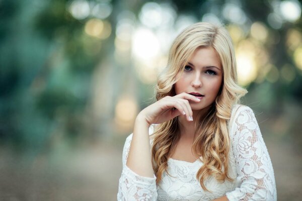 Blonde model in a white dress