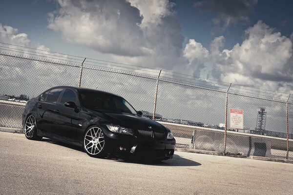 Black BMW near the fence