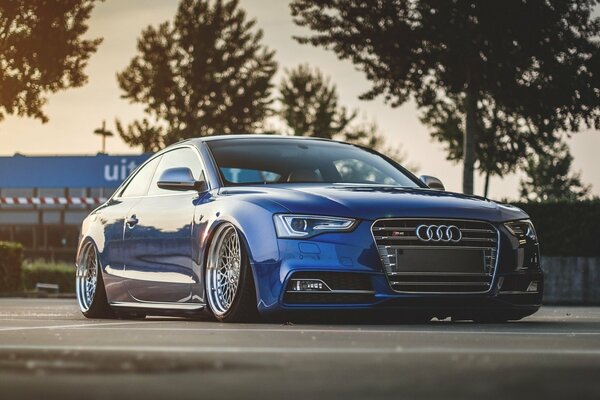 Parked blue Audi on cool wheels