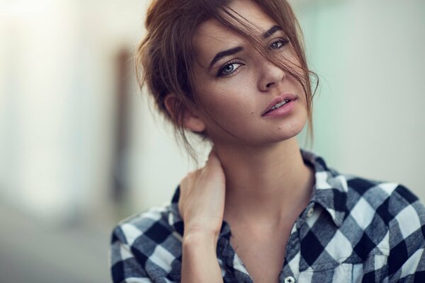 Elegante chica en camisa a cuadros