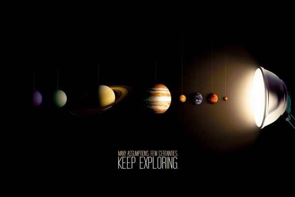 A row of planets of the solar system under the light of a lamp