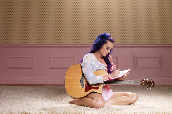 Katy Perry composes music with guitar