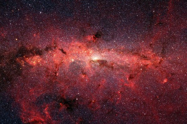 Muchas estrellas forman un resplandor rojo en el espacio