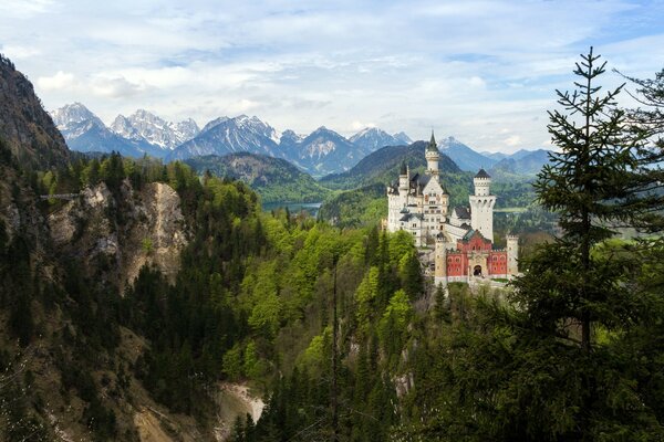 Bavarian castle in the forest among the mountains