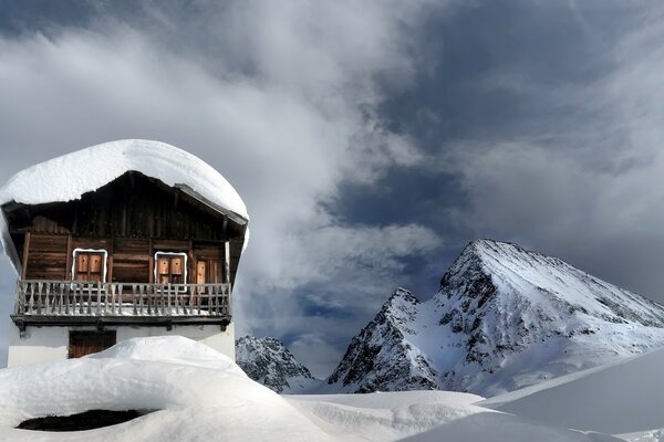 A house in the mountains. Snow. mountains