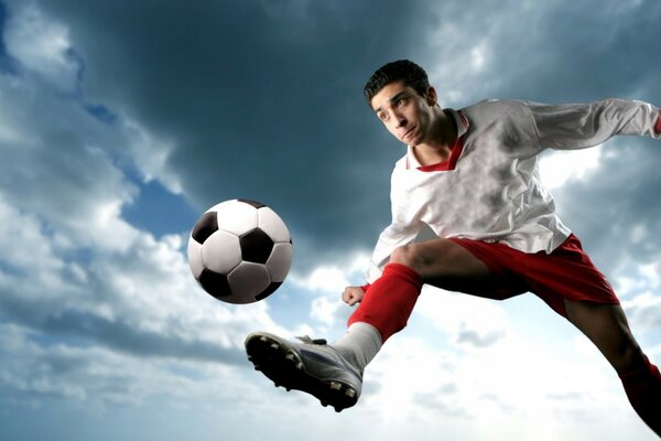 Photo of a football player hitting the ball