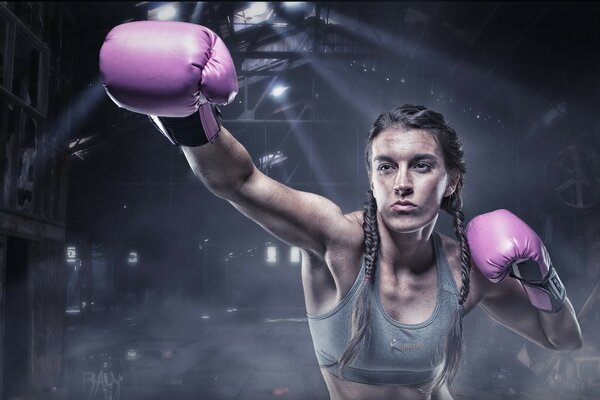 A girl at a sport in boxing gloves