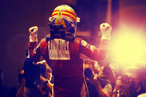 Fernando Alonso stands in front of reporters