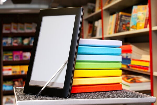 A tablet resting on a stack of books