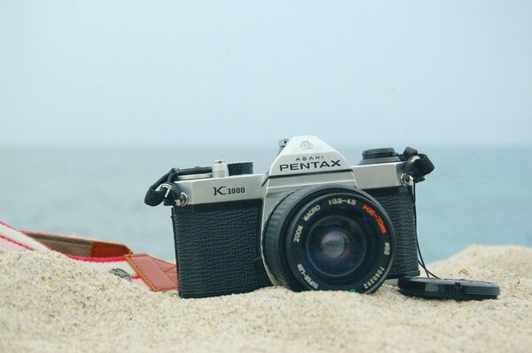 Pentax camera on the sandy shore