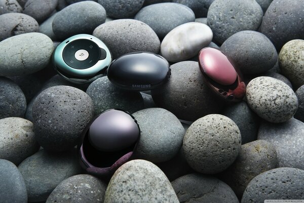 Photo of gadgets on gray pebbles