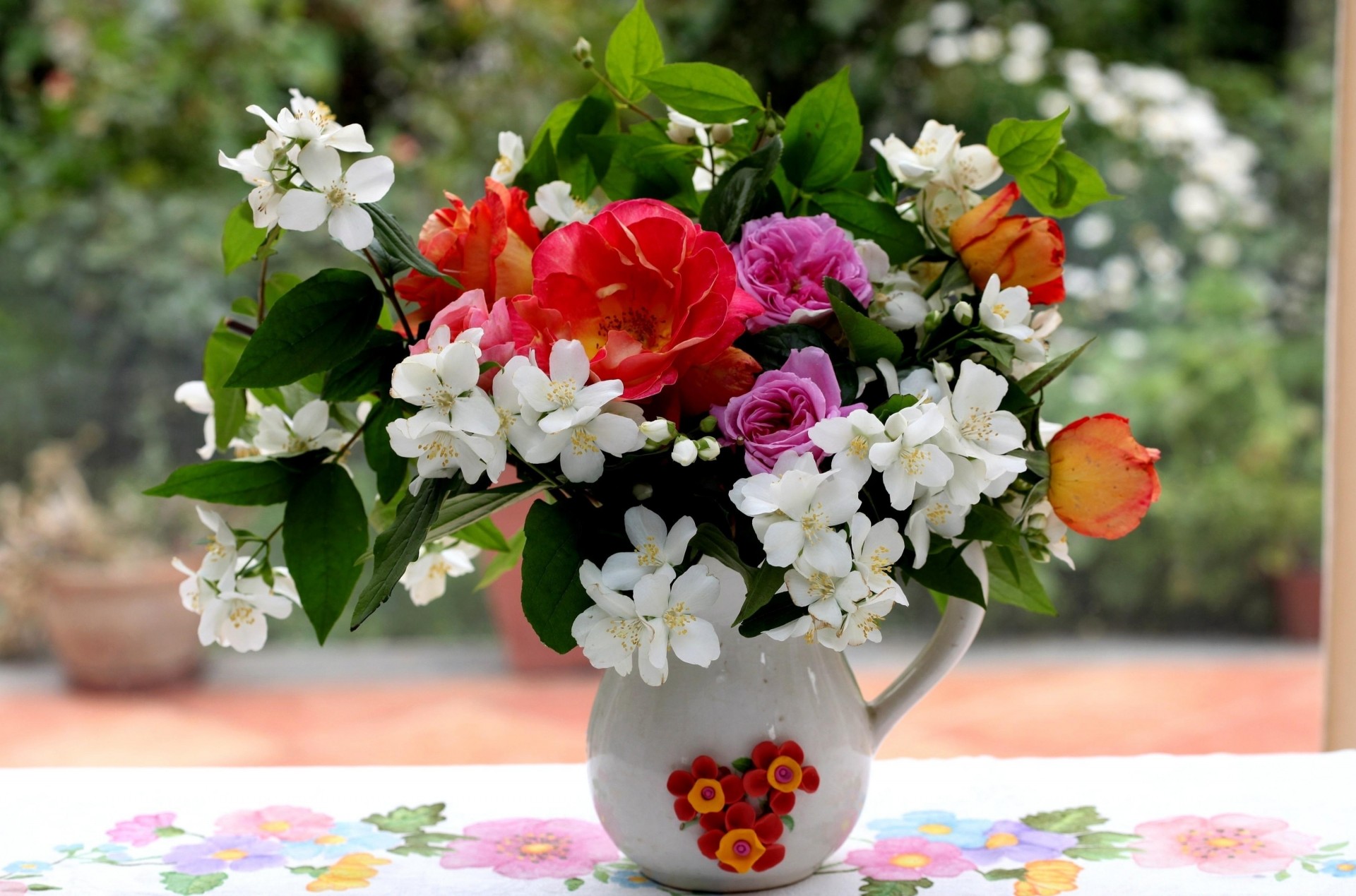 heet roses bouquet flower jasmine branches pitcher table