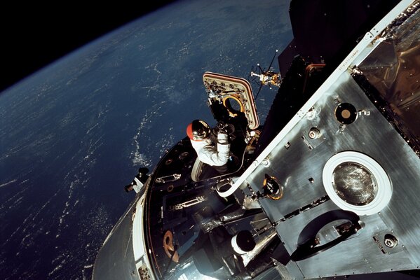 NASA astronaut in outer space gets out of the ship