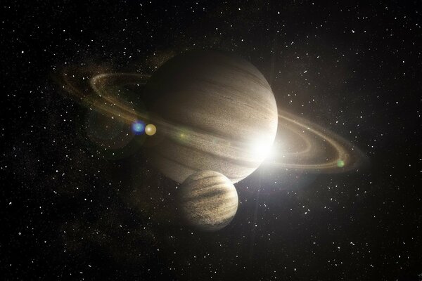 Saturn with its satellite on the background of stars