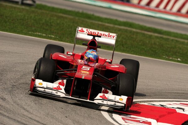 Racing Ferrari goes into a turn