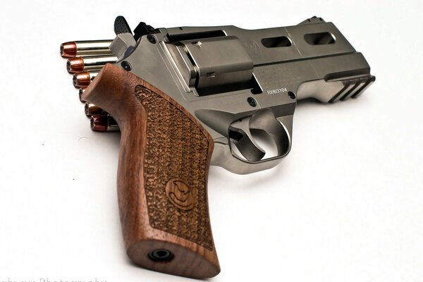 A revolver with cartridges is depicted on a white background