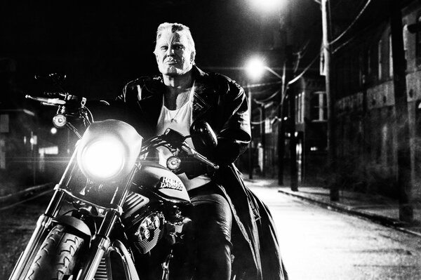 Mickey Rourke on a motorcycle in black and white background