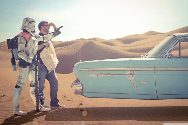 Dos personas en el desierto y un coche