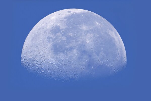 Silver half of the moon on a blue background