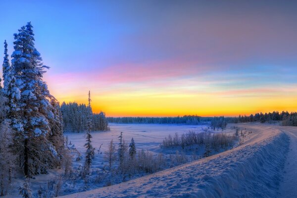 Winter road going into the sunset