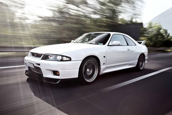 White nissan skyline on the road