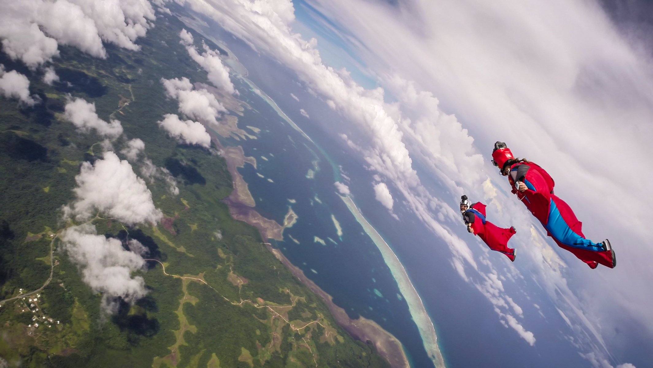 wingsuit piloten bildung helm kamera wolken schatten meer insel container fallschirm extremsport