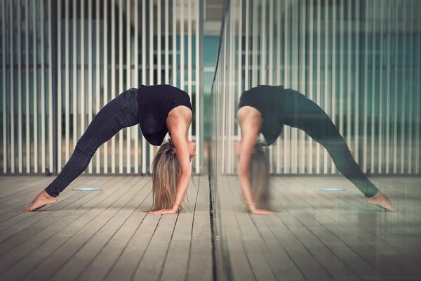 Graceful gymnast girl and her reflection