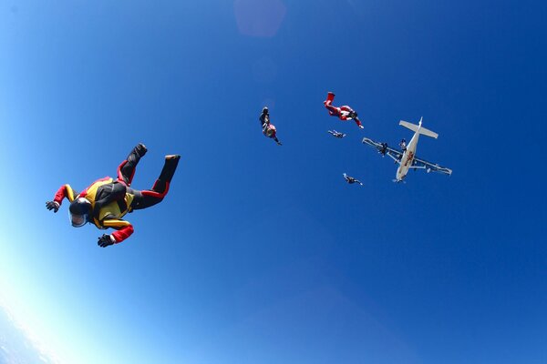 Parachutists soaring in the blue sky