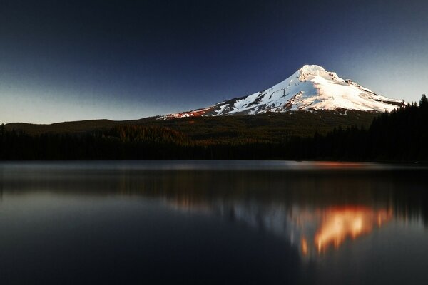 Snowy peak by the lake