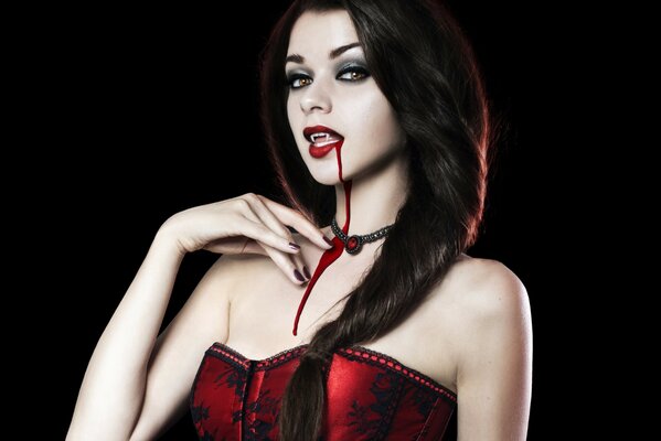 Beautiful vampire girl with fangs