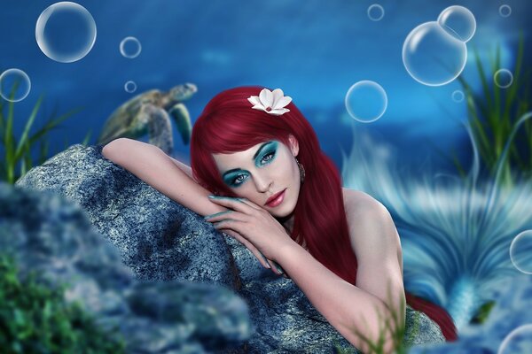 Red-haired mermaid with make-up under water