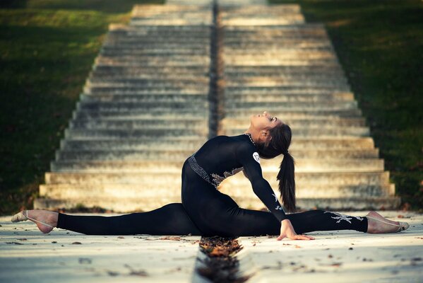 A girl in a black suit on a twine