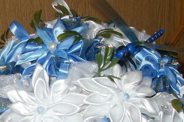 Beautiful flowers from ribbons with a blue dragonfly