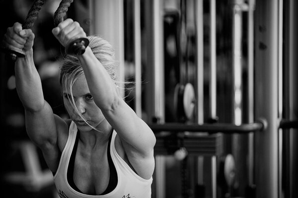 A girl in the gym performs exercises