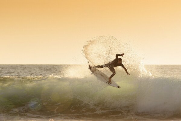 Surfer conquers the sea wave