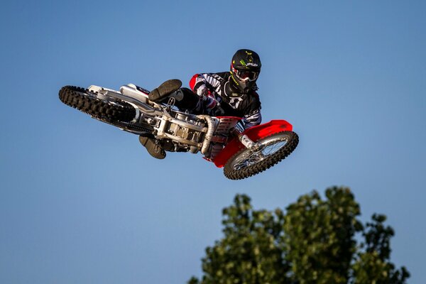 A motorcyclist performs a trick in the air