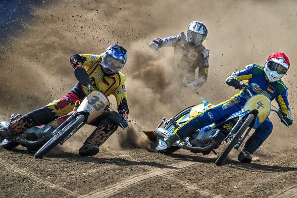 Three motorcyclists on a turn during a sports race