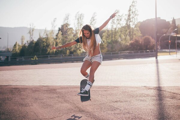 Beautiful athletic girl on a skateboard